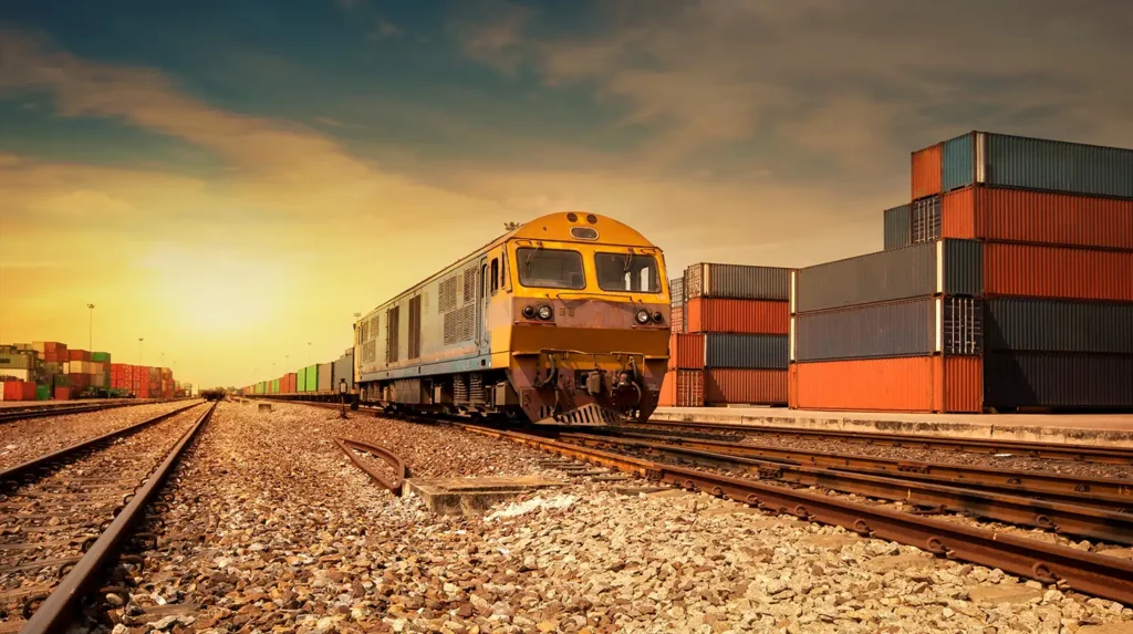 A train on a railroad track next to cargo containers to illustrate cargo theft