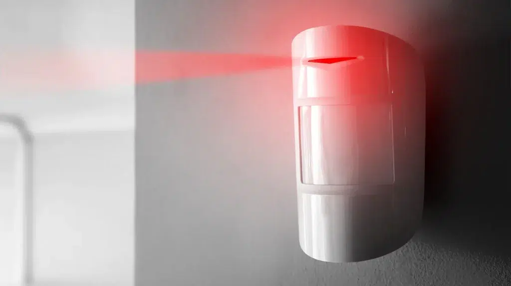 alarm on wall with red light streaming out