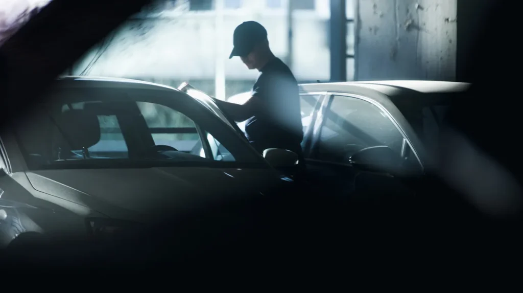 a man standing next to a car