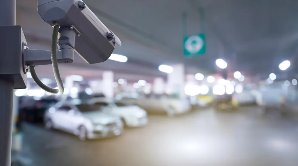 security camera in a parking garage filled with vehicles