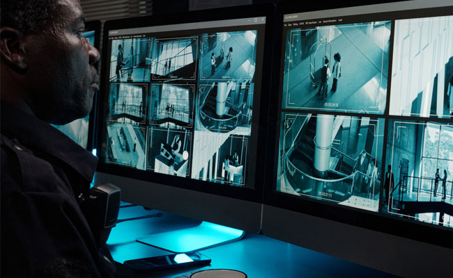 guard watching security monitors