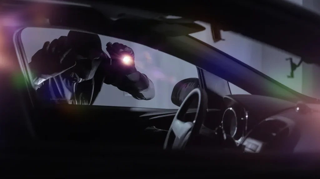 Masked person with flashlight peering into vehicle window