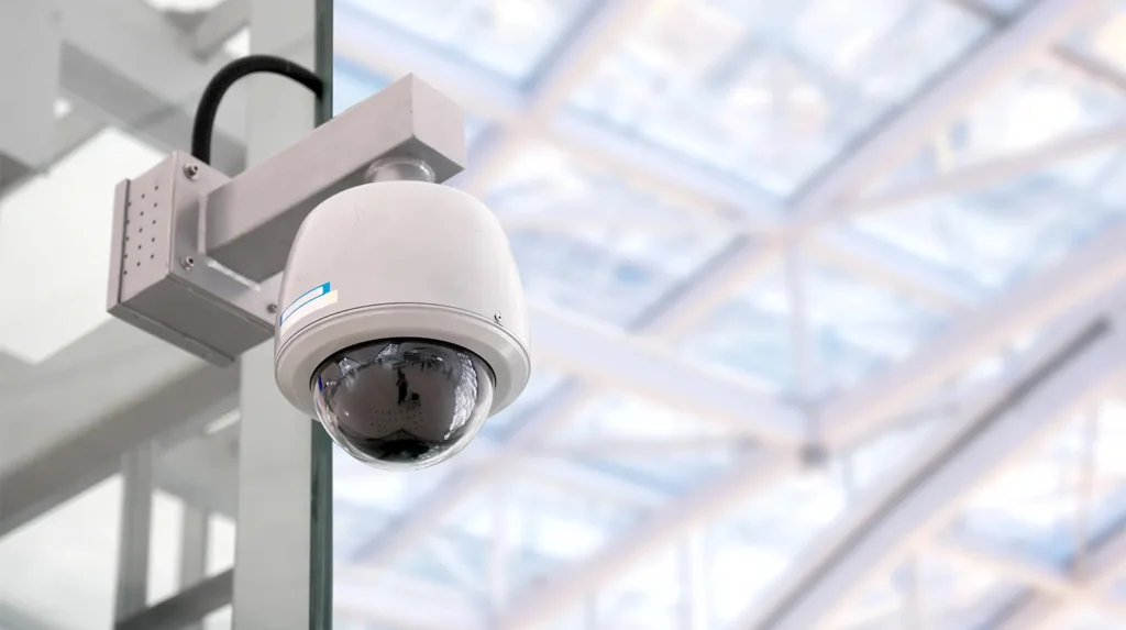 a white dome camera on a pole
