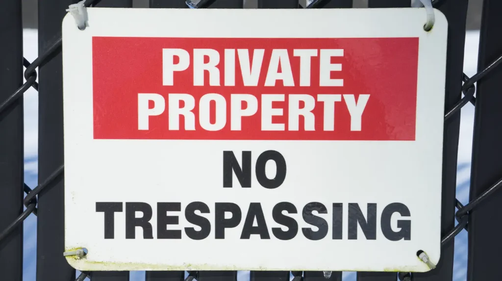 Trespassing sign to illustrate trespassing definition
